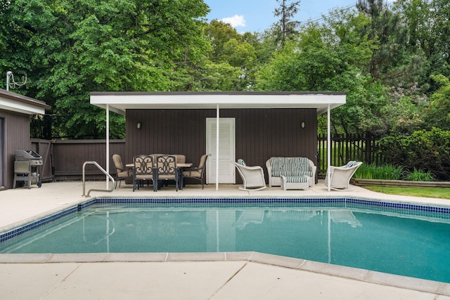 view of swimming pool with a patio and area for grilling