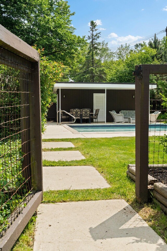 3586 E Huron River Dr, Ann Arbor, MI 48104 - view of yard with an outdoor pool and a patio