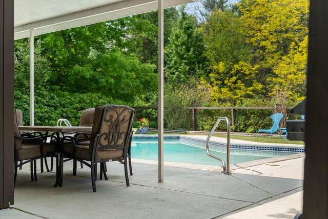 3586 E Huron River Dr, Ann Arbor, MI 48104 - view of swimming pool featuring a patio, outdoor dining area, and view of wooded area