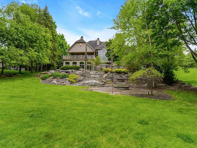 view of yard with a balcony