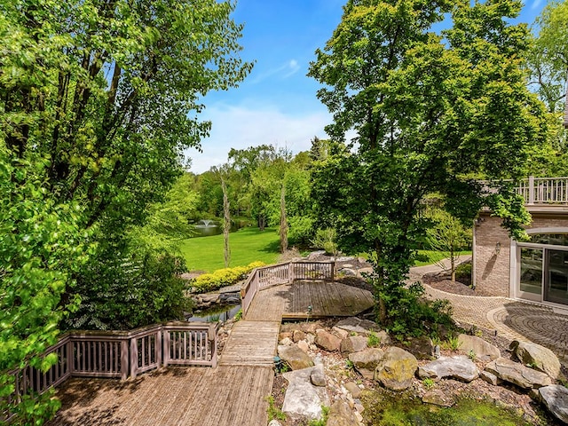 view of yard featuring a deck with water view