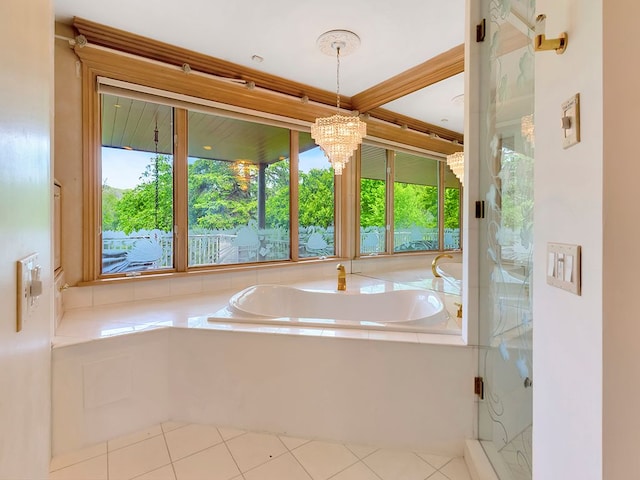 bathroom with tile patterned flooring, an inviting chandelier, separate shower and tub, and a healthy amount of sunlight