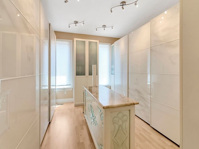 spacious closet with light hardwood / wood-style floors