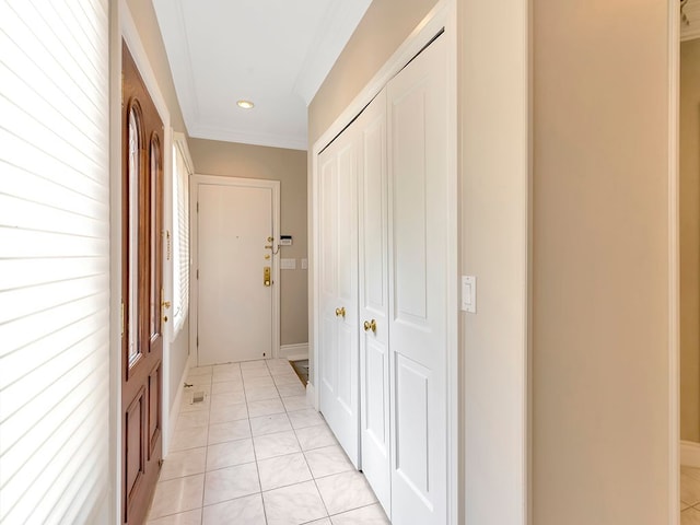 hall featuring light tile patterned floors and crown molding