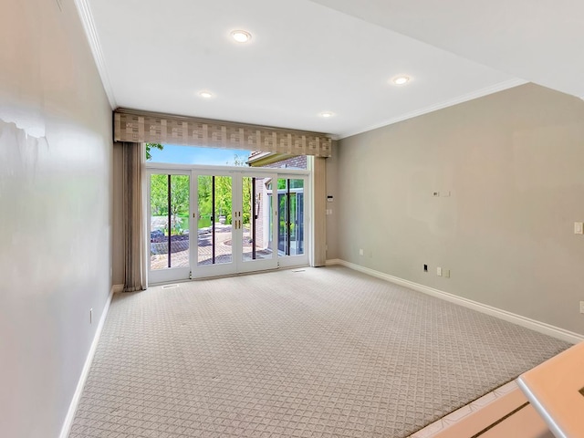 unfurnished room with carpet flooring, crown molding, and french doors