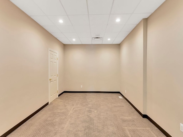 carpeted spare room with a paneled ceiling