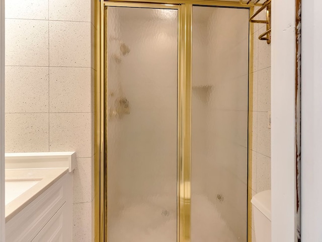 bathroom with vanity, an enclosed shower, and toilet