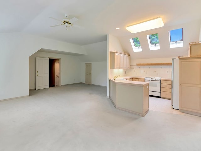 kitchen featuring white electric range, lofted ceiling with skylight, ceiling fan, and sink