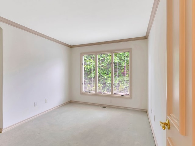 carpeted empty room featuring crown molding