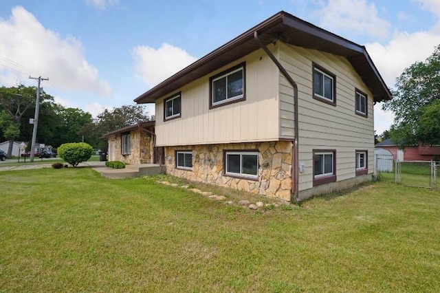 view of home's exterior with a lawn