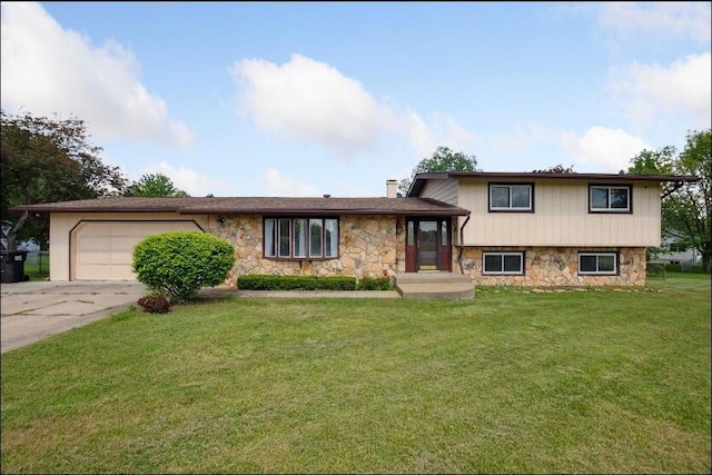 tri-level home with a front lawn and a garage