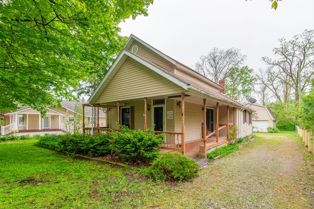 view of property exterior featuring a lawn and covered porch