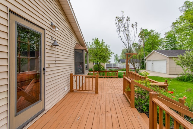 deck with a garage and an outdoor structure