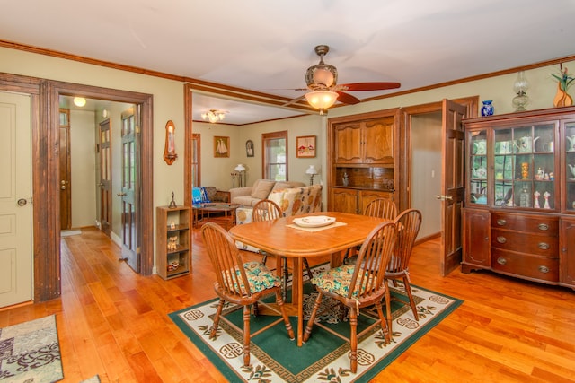 dining space featuring ceiling fan, ornamental molding, and light hardwood / wood-style flooring