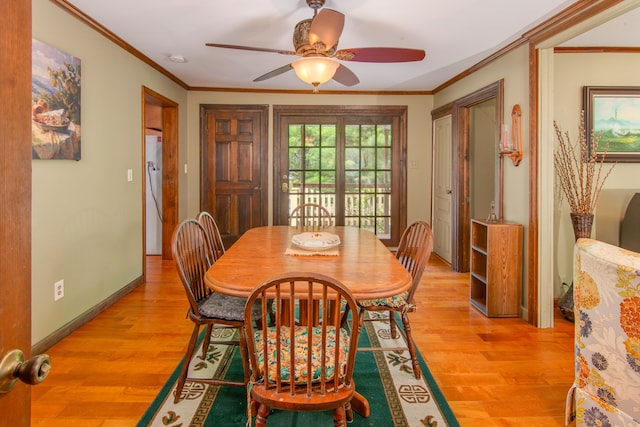 dining space featuring light hardwood / wood-style flooring, ceiling fan, and crown molding