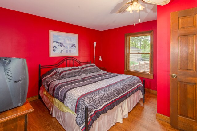 bedroom with hardwood / wood-style floors and ceiling fan