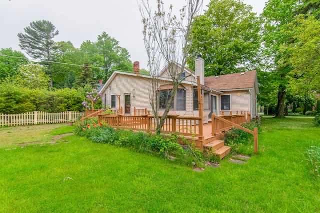 back of property featuring a lawn and a deck