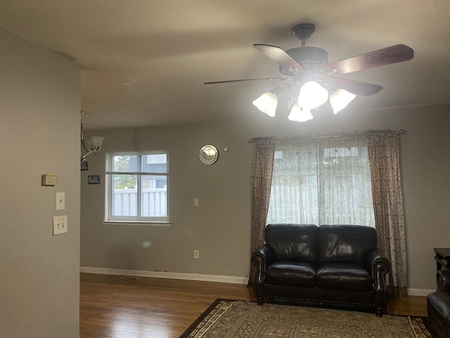 living room with hardwood / wood-style flooring and ceiling fan