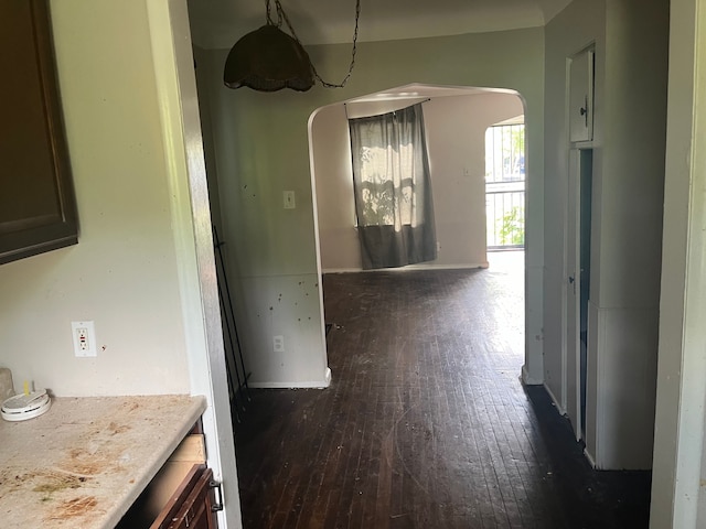 unfurnished dining area with dark wood-type flooring