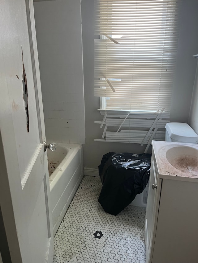 bathroom featuring tile patterned floors, vanity, and a bath