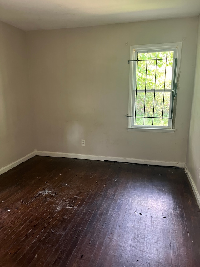 spare room with dark wood-type flooring