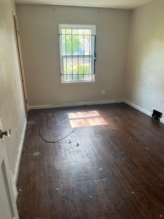 unfurnished room featuring dark hardwood / wood-style floors