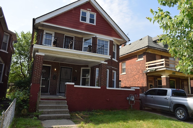 view of front of property featuring a balcony and covered porch