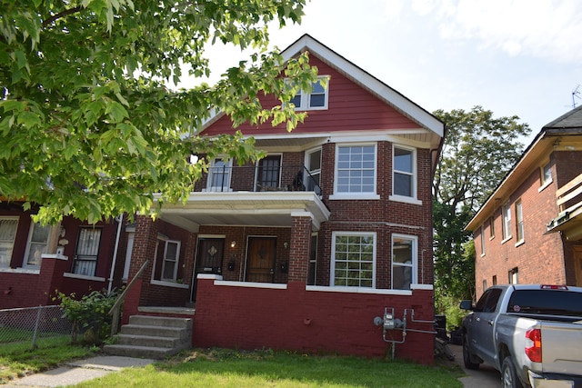 view of front of home featuring a balcony and covered porch