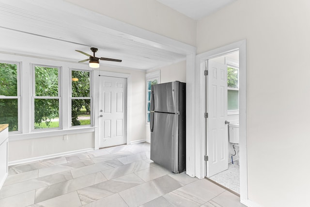 kitchen with plenty of natural light, ceiling fan, and stainless steel refrigerator