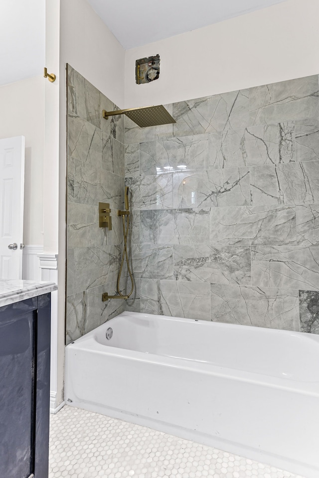 bathroom featuring vanity, tile patterned floors, and tiled shower / bath