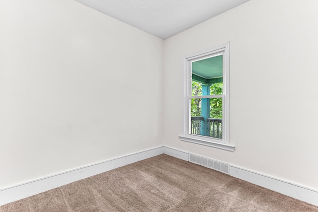 unfurnished room featuring carpet flooring