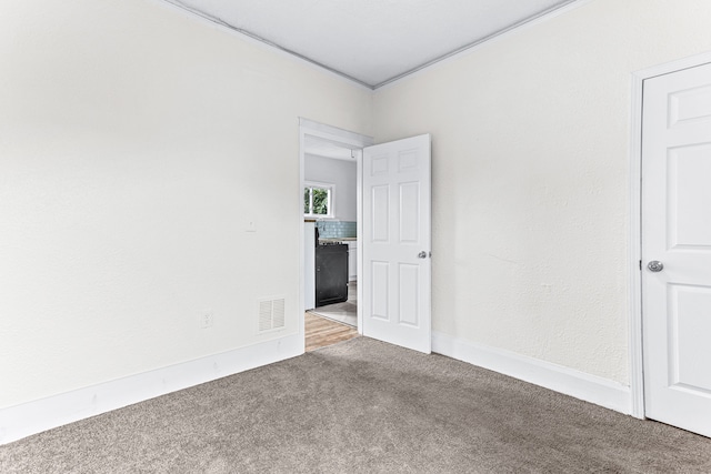 carpeted empty room with ornamental molding