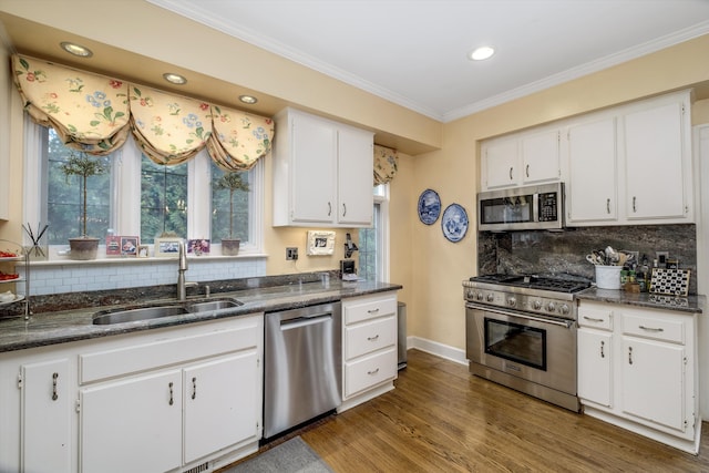 kitchen featuring sink, ornamental molding, dark hardwood / wood-style flooring, white cabinetry, and stainless steel appliances