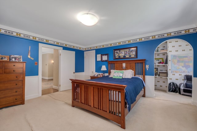 bedroom with carpet flooring and crown molding