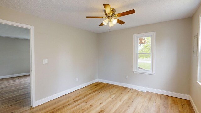 7200 E Tomah Rd, Mount Pleasant, MI 48858 - unfurnished room featuring wood finished floors, baseboards, and ceiling fan