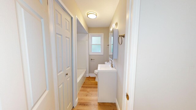 7200 E Tomah Rd, Mount Pleasant, MI 48858 - bathroom featuring toilet, wood finished floors, vanity, and baseboards