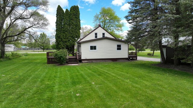 7200 E Tomah Rd, Mount Pleasant, MI 48858 - back of property with a wooden deck and a lawn
