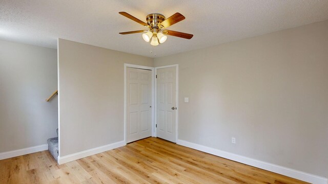 7200 E Tomah Rd, Mount Pleasant, MI 48858 - unfurnished bedroom featuring light wood-type flooring, baseboards, and ceiling fan
