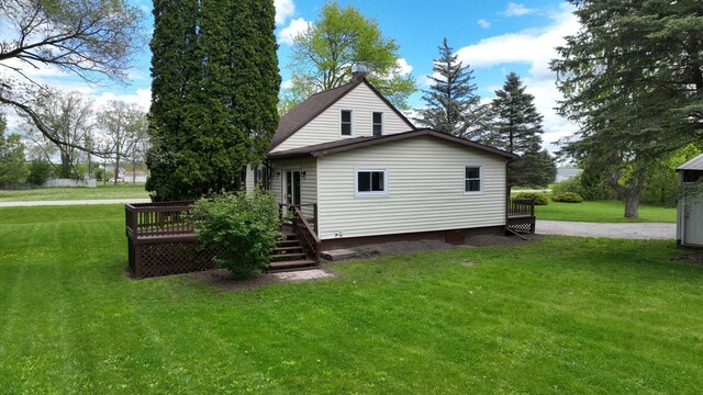 7200 E Tomah Rd, Mount Pleasant, MI 48858 - view of side of home with a deck and a lawn