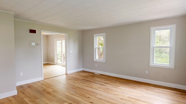 7200 E Tomah Rd, Mount Pleasant, MI 48858 - spare room with light wood finished floors, baseboards, and crown molding