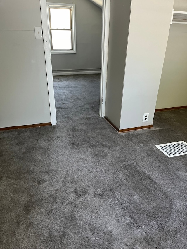 carpeted empty room with lofted ceiling