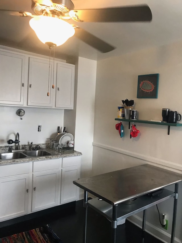 kitchen featuring sink, ceiling fan, and white cabinets