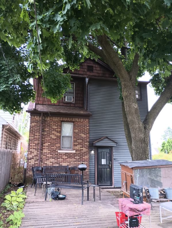 rear view of property featuring a deck