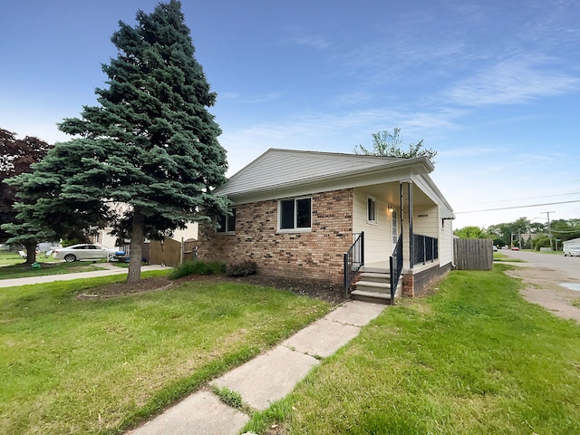 bungalow-style house featuring a porch and a front lawn