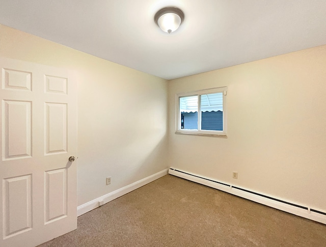 carpeted empty room featuring a baseboard radiator