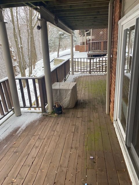 snow covered deck with covered porch