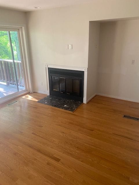 unfurnished living room with hardwood / wood-style flooring