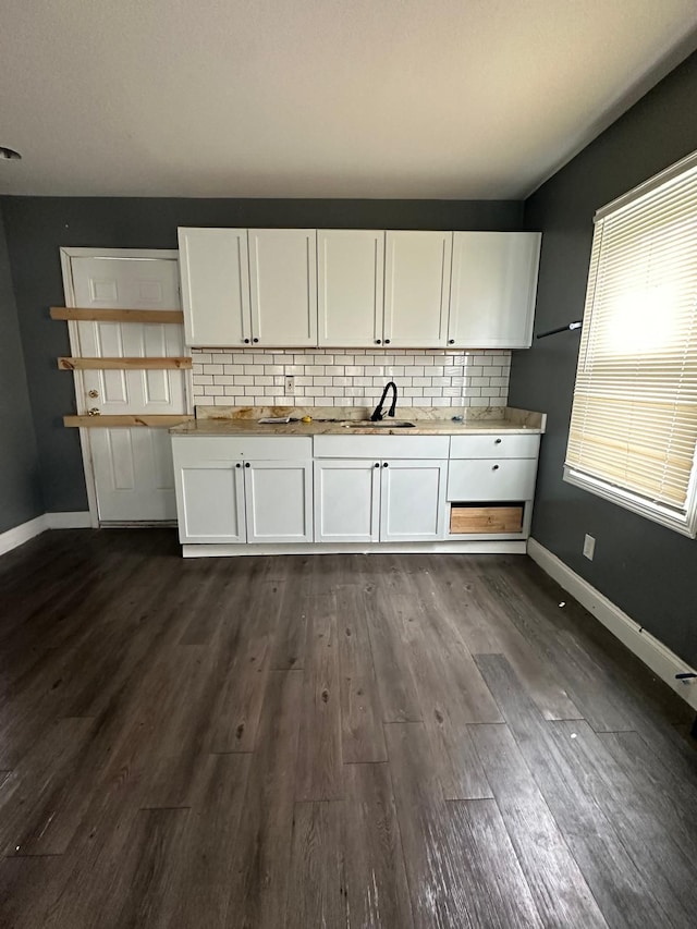 kitchen with white cabinets, tasteful backsplash, dark wood-type flooring, and sink