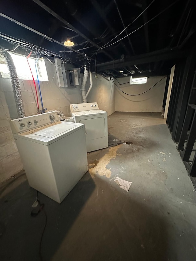 basement featuring electric panel and separate washer and dryer