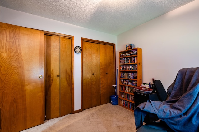 living area with light carpet and a textured ceiling